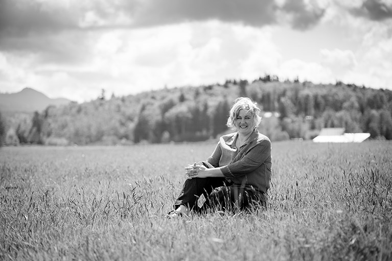 Marie de Haan sitting alone in a field